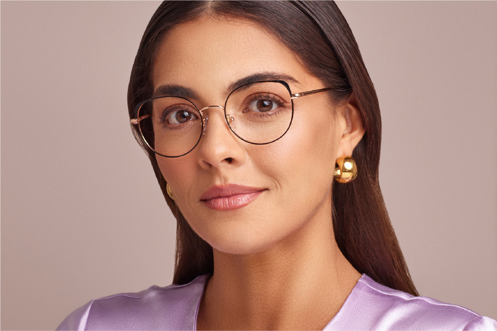Shel eyeglasses frame worn by model.